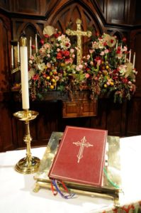 Bible and candle at altar